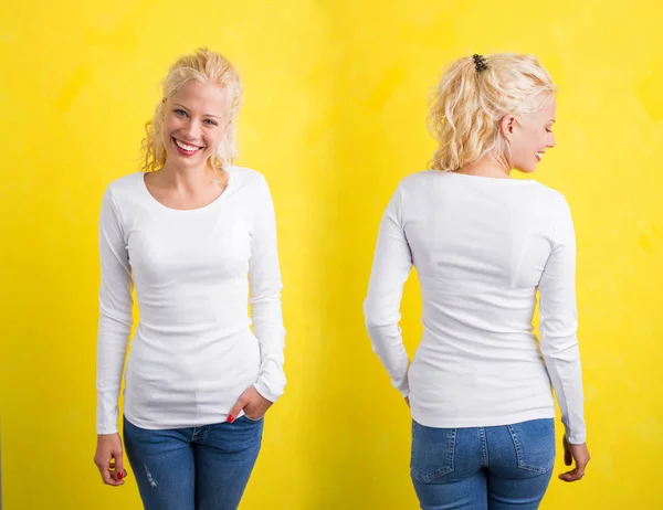 Frau in weißem Langarmshirt auf gelbem Hintergrund — Stockfoto