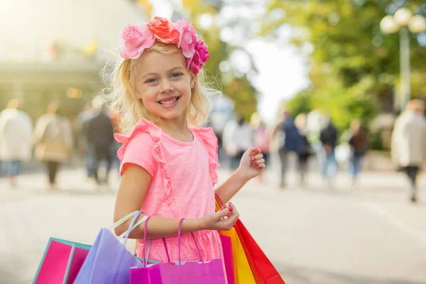 Little fashionista holding shopping bags — Stock Photo, Image