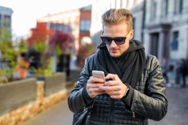 yakışıklı bir adam onun smartphone kullanarak