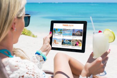 Woman reading travel blog on tablet clipart