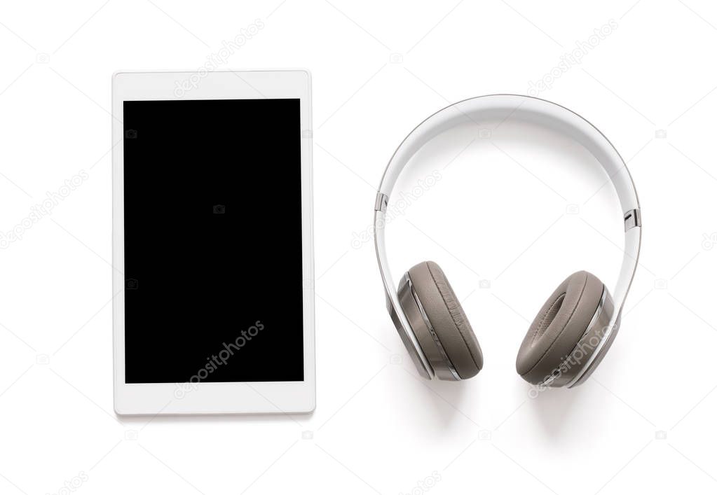 Headphones and tablet isolated on white