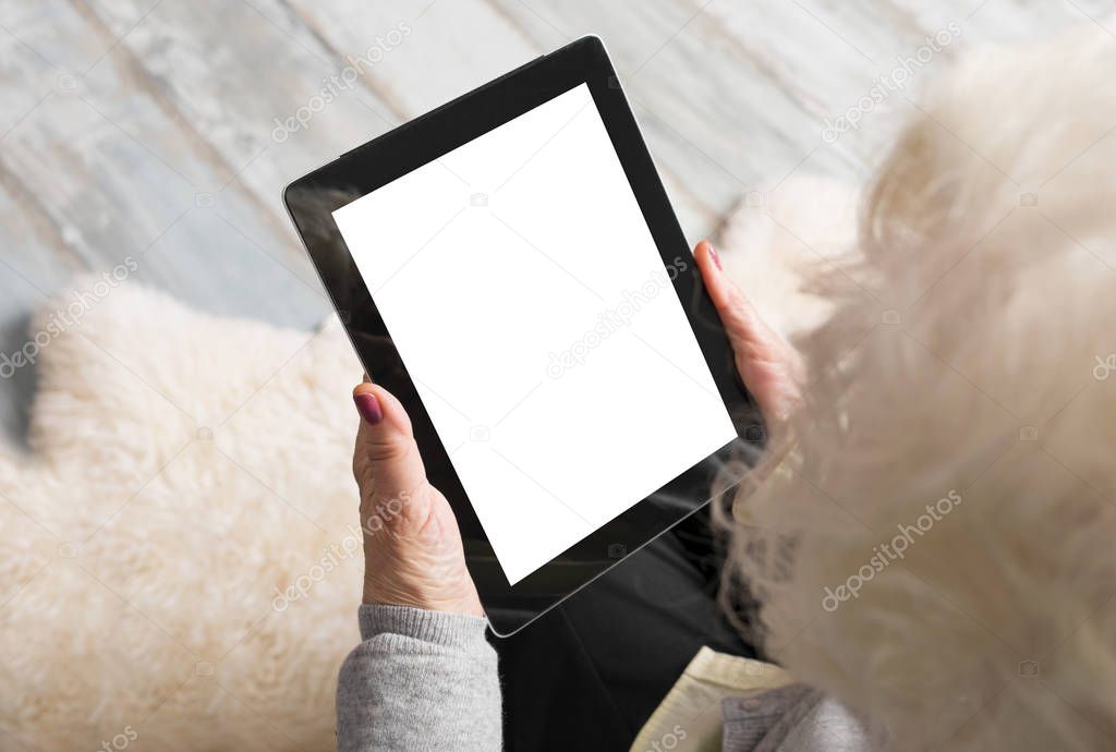 Old woman using blank screen tablet