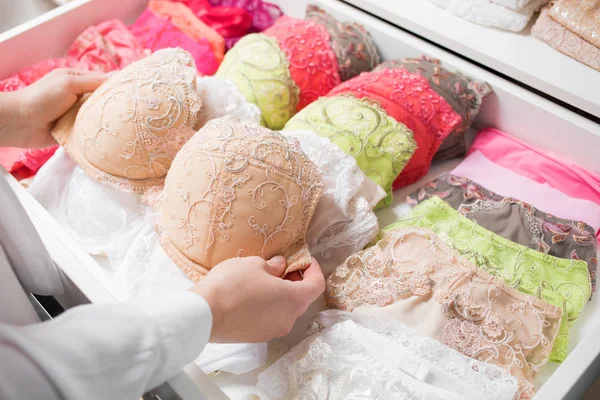 Woman organizing underwear in drawer — Stock Photo, Image