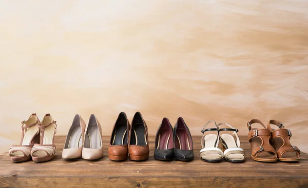 Organized woman's shoes on wooden floor — Stock Photo, Image