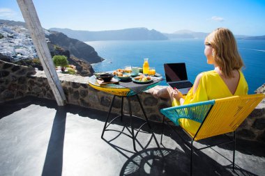 Akdeniz'de tatil sırasında dizüstü ile çalışan kadın