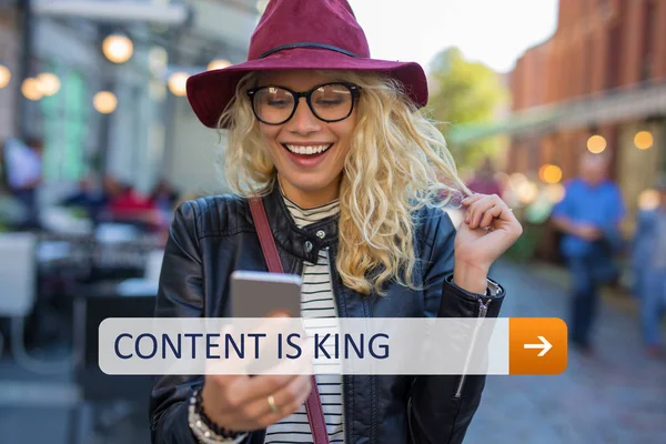 Content is king. Woman looking at smartphone
