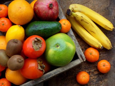 Kompozisyon Mix tropikal ve Akdeniz meyve ahşap arka plan üzerinde renkli. Kavramlar hakkında dekorasyon, sağlıklı yeme