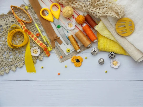 Composition of yellow accessories for needlework on wooden background. Knitting, embroidery, sewing. Small business. Income from hobby. — Stock Photo, Image