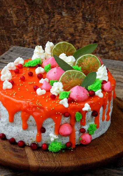 Poppy seed cake covered with red mirror glaze and decorated with meringue, lime slices, leaves of sage. selective focus. copy space — Stock Photo, Image