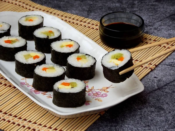 Sushi auf weißem Teller, grauer Hintergrund. traditionelle asiatische Küche. Ernährung gesunde Ernährung. Selektiver Fokus. Raum für Text — Stockfoto