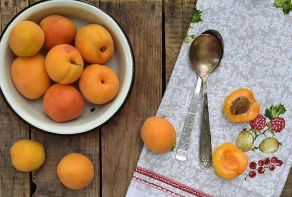 Fresh fruits on wooden background. Ripe apricot in bowl on the kitchen table. — Stock Photo, Image