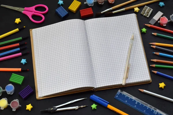 Школьные принадлежности и принадлежности: карандаши, маркеры, краски, ручки, доска для надписей на темном фоне. Возвращайся в школу. Вид сверху. Плоский лежал — стоковое фото