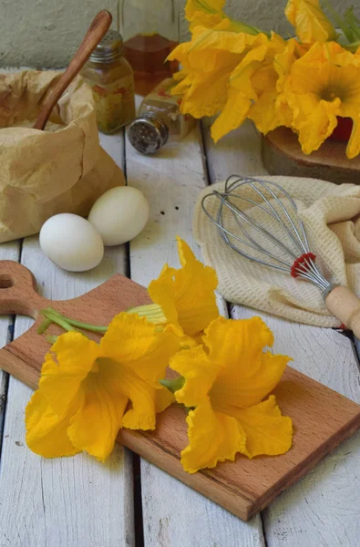 Приготування свіжих квітів кабачків, обсмажених в яєчному ящику на світлому дерев'яному фоні . — стокове фото