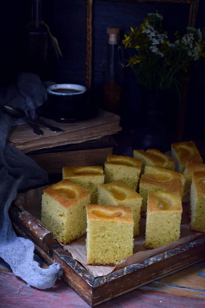 Homemade corn cake with tangerines on dark background. Traditional Brazilian sweet pie. Cornbread. Style Dark Moody — Stock Photo, Image