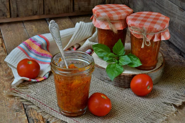 Jars of tomato sauce with chili, pepper and garlic. Bolognese sauce, lecho or adjika. Preservation. Canning — Stock Photo, Image