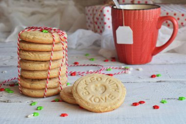 Noel ve yılbaşı tatil kutlama kavramı arka plan. Bir fincan çay, ev yapımı somun kurabiye, kurabiye, xmas ağacı süsle ahşap tablo