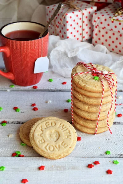 Kerstmis en Nieuwjaar vakantie feest concept achtergrond. Mok thee, zelfgemaakte moer cookie, zandkoek, xmas boom decoratie op houten tafel — Stockfoto