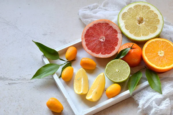 Set of citrus on light background: orange, mandarin, lemon, grapefruit, lime, kumquat, tangerine. Fresh organic juicy fruits. Source of vitamin C. Healthy food concept. Copy space — Stock Photo, Image