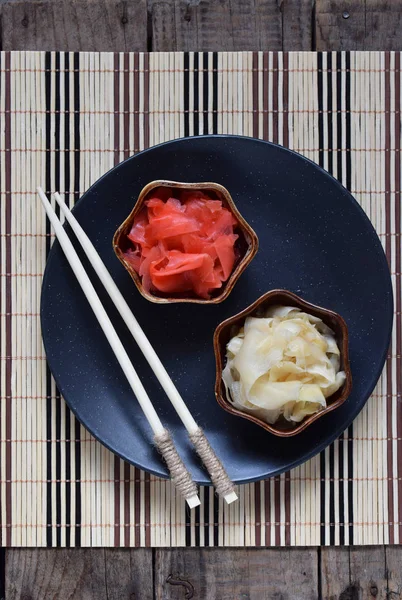 Eingelegte Ingwerscheiben und Stäbchen aus Holz. Zutat für Sushi. Gesunde Ernährung. traditionelle japanische Würze. — Stockfoto