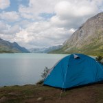 Tourist tent in camping at beautiful Gjende lake, Besseggen ridge, Jotunheimen National Park, N
