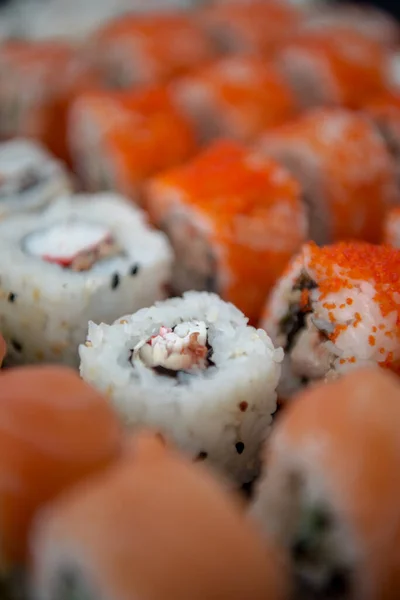 Japanese food. Sushi. Philadelphia roll with fresh salmon, cucumber, avocado, cream cheese, tobiko caviar. Sushi menu. Top view