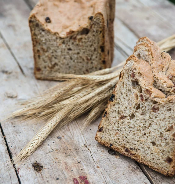 Fresh rye bread or whole grain bread on dark table background. Healthy baked bread in slices, whole homemade bread. Organic farm food.