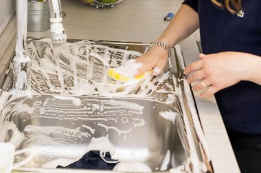 mutfak lavaboda ev işleri yaparak bir kadın