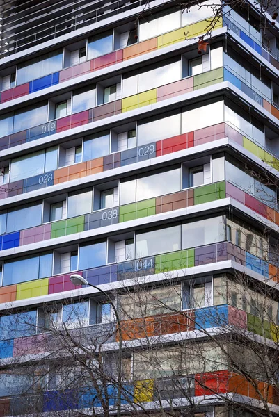 Modern building with colored and numbered glass balconies. — Stock Photo, Image