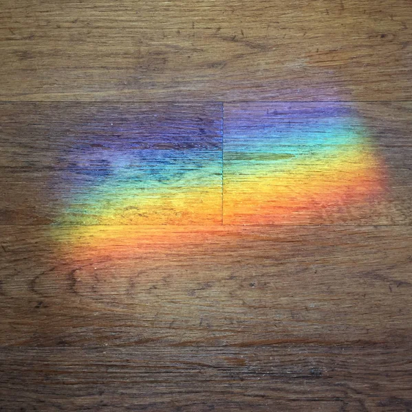 Farbprisma auf einen Holzboden projiziert — Stockfoto