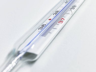 Beyaz arka planda izole edilmiş cıva bir termometre. Tıbbi ölçüm aleti. Virüs ve grip