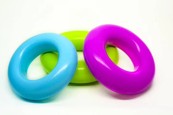 three colored plastic rings isolated on a white background. Children\'s toys for stacking. Preschool education and fun