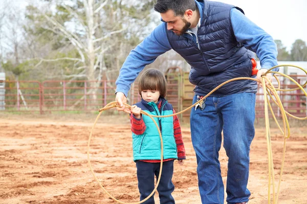 Father learning son making loop and throwing lasso in ranch — Stock Photo, Image