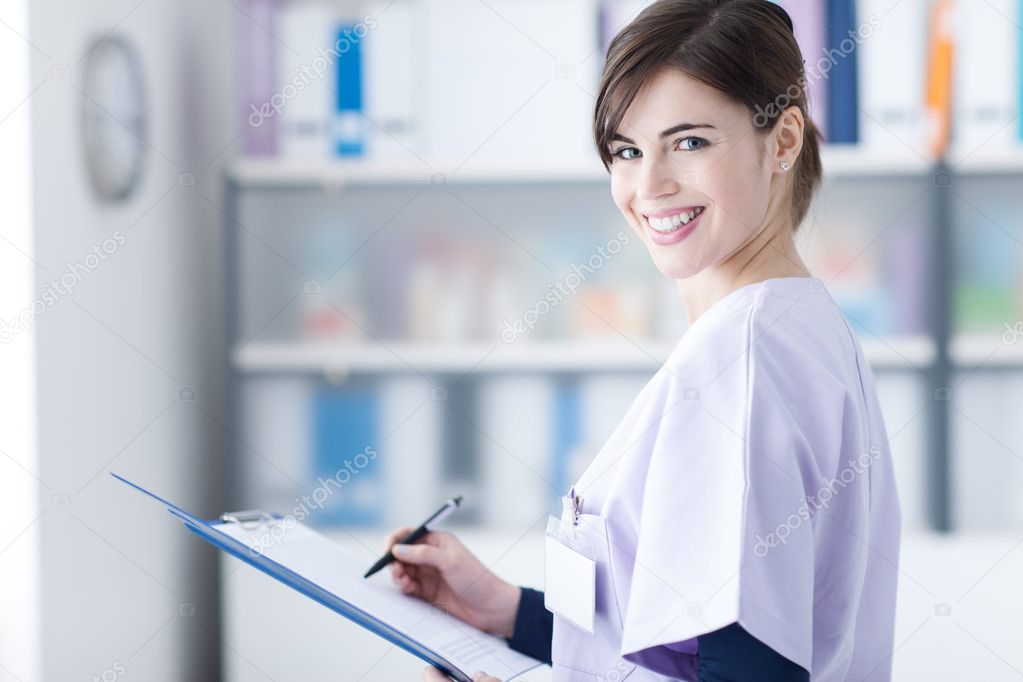 Smiling doctor writing medical reports