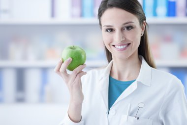 Dentist holding a green apple clipart