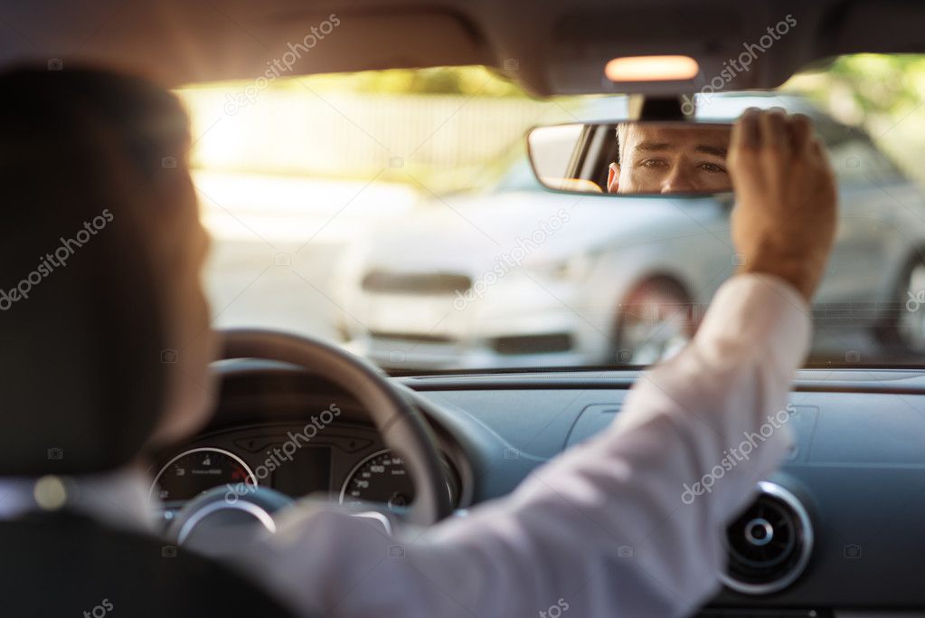 Man adjusting a rearview mirror — Stock Photo © stockasso 124984254