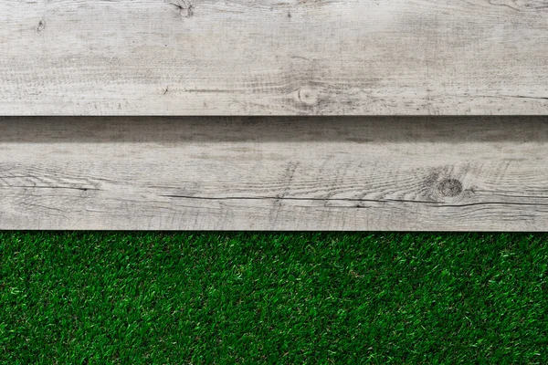 Wooden table and grass — Stock Photo, Image