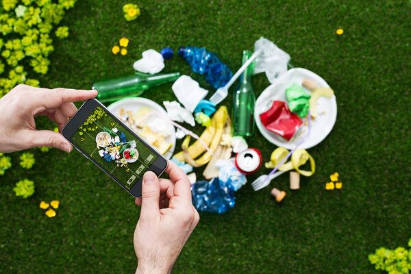 Man taking a picture of garbage