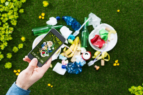 Man taking a picture of garbage