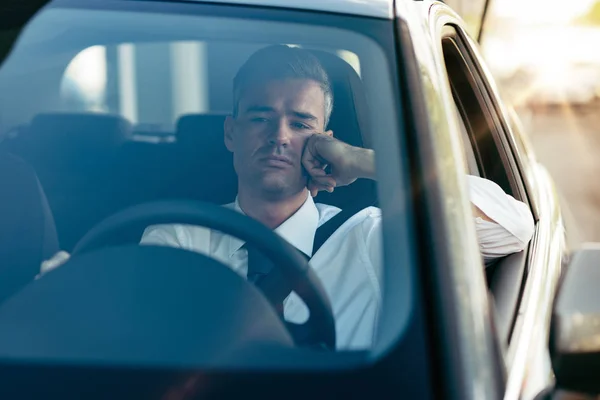 Pensive businessman in his car — Stock Photo, Image