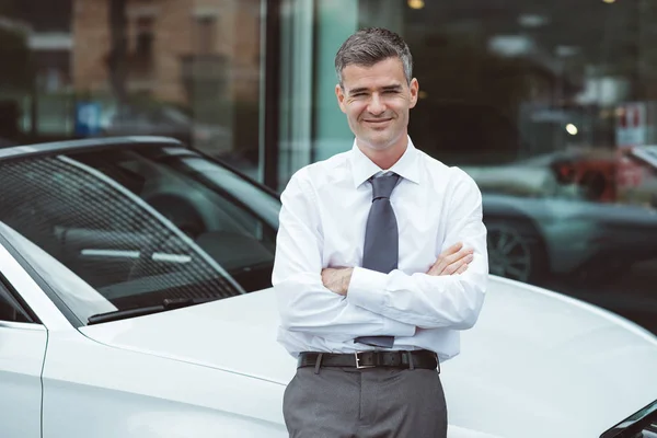 Uomo d'affari in posa con la sua nuova auto — Foto Stock