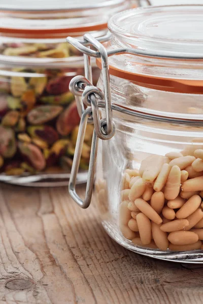 Pine nuts and pistachios in a jar — Stock Photo, Image