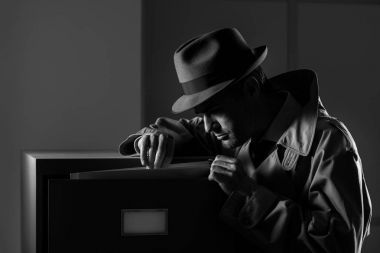 Undercover spy stealing files clipart