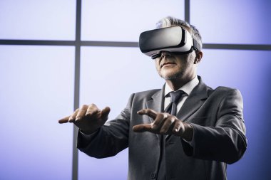 Businessman interacting with virtual reality clipart