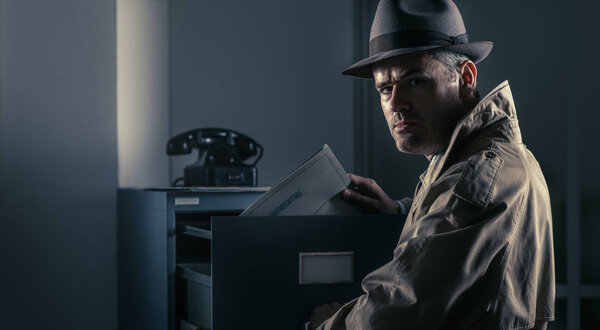 Vintage spy stealing files in the office