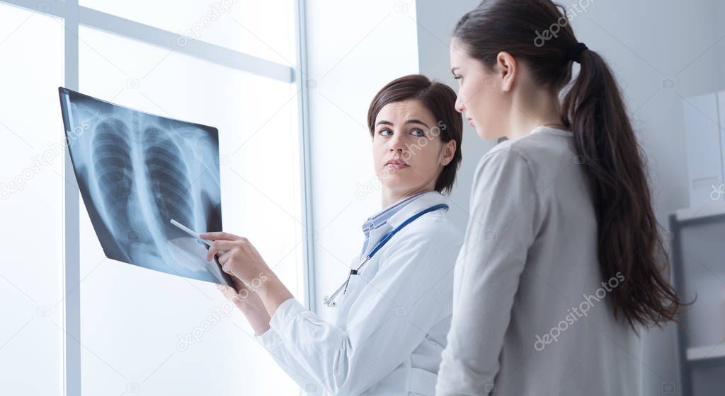 Doctor examining patient's x-ray
