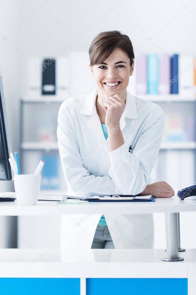 Attractive doctor posing at the clinic reception