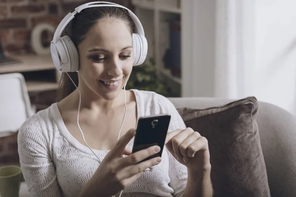 Gelukkig Jongedame Luisteren Naar Muziek Thuis Met Haar Smartphone Aansluiten — Stockfoto
