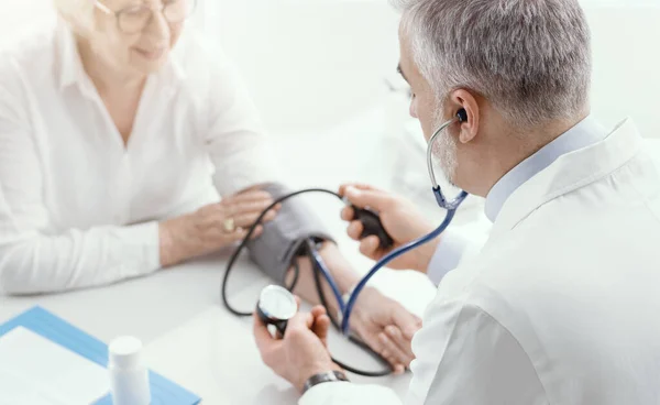 Profesjonalny Lekarz Mierzący Ciśnienie Krwi Starszej Pacjentki Podczas Wizyty Nadciśnienie — Zdjęcie stockowe