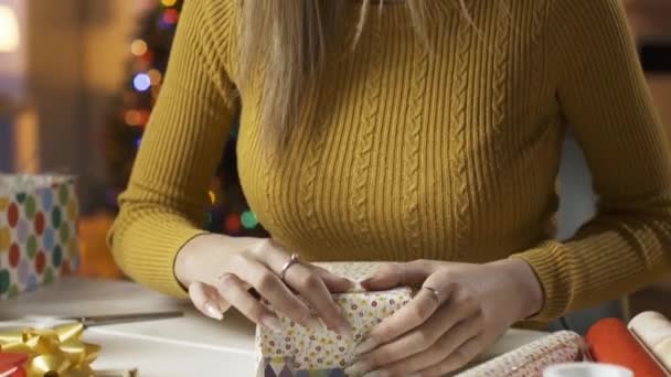 Jeune femme préparant des cadeaux de Noël à la maison — Video