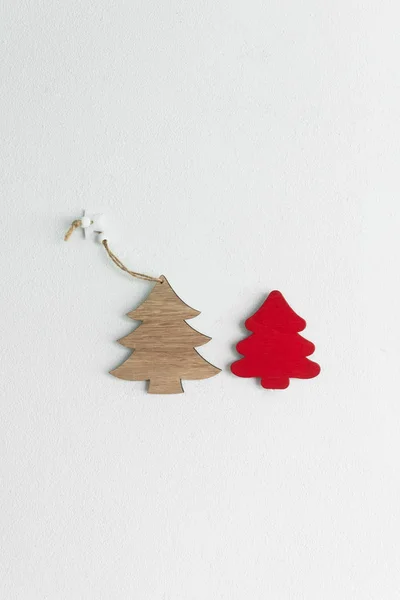 red brown wood craft Christmas tree on white cement wall backgro